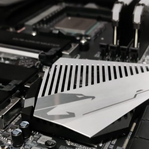 Close-up of a high-performance motherboard with an AORUS M.2 heatsink, highlighting quality components used in PCExperts101's custom PC building and repair services.